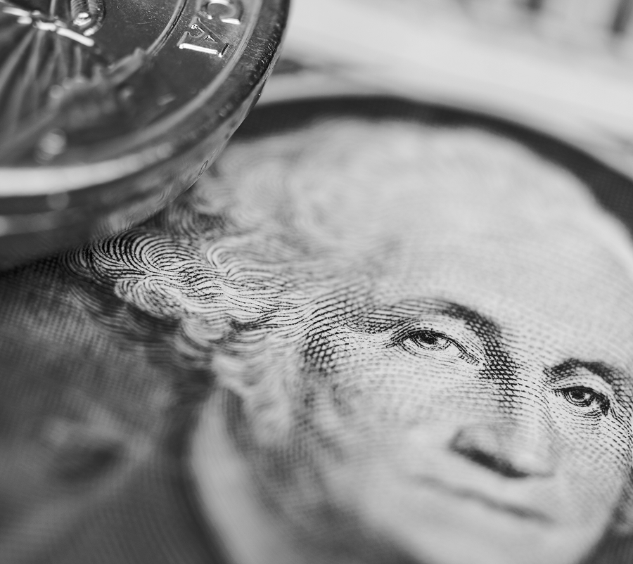 Close-up black and white image of part of a quarter coin and the portrait of George Washington on a U.S. dollar bill, representing value—ideal for campaigns about financial growth or strategies like email marketing or SEO.