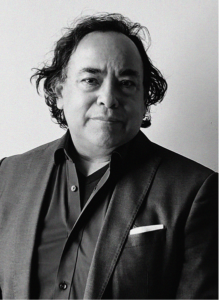 Black-and-white portrait of a middle-aged man with wavy hair, wearing a suit jacket, dress shirt, and pocket square, facing the camera against a plain background—perfect for marketing or CRM professional profiles.