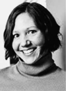 Black and white photo of a woman with short dark hair, wearing a turtleneck sweater, smiling at the camera—perfect for personal branding or digital marketing profiles.