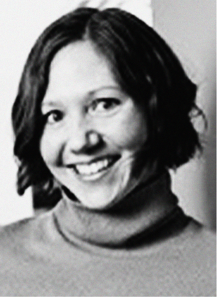 Black and white photo of a woman with short dark hair, wearing a turtleneck sweater, smiling at the camera—perfect for personal branding or digital marketing profiles.