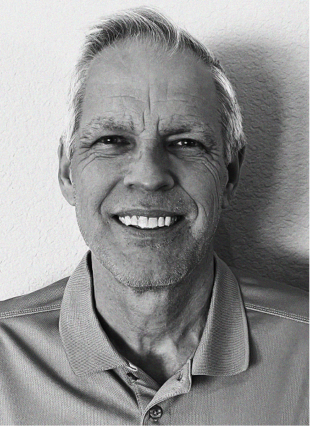 Black and white portrait of an older man with short hair, smiling in a collared shirt, against a plain background—perfect for marketing or search engine optimization profiles.