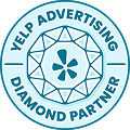 Circular blue badge with "Yelp Advertising Diamond Partner" text surrounding a diamond design and Yelp logo in the center.